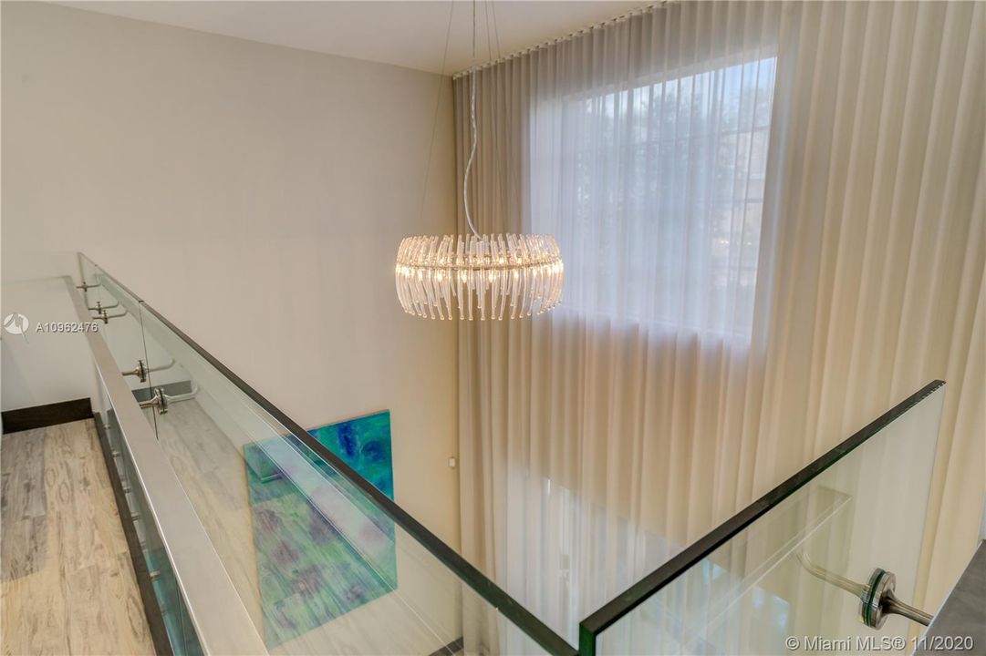 21 ft. high ceiling with amazing glass chandelier and custom made drapes