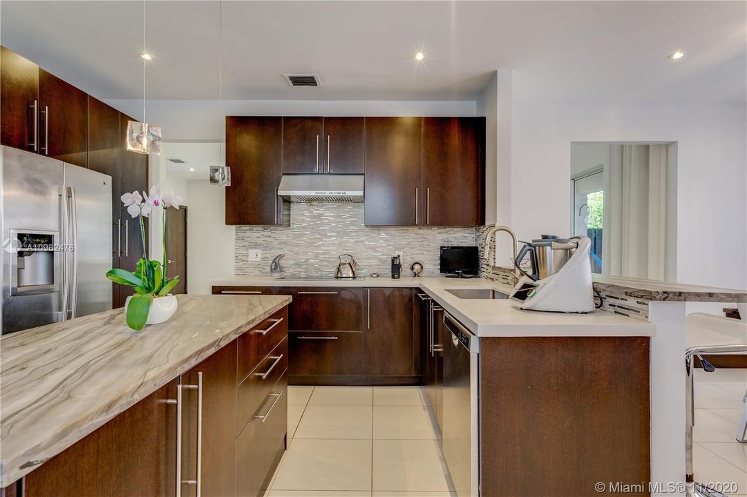 Completely remodeled with modern contemporary high end features including dual granite kitchen countertops with bar and island, and stainless steel appliances