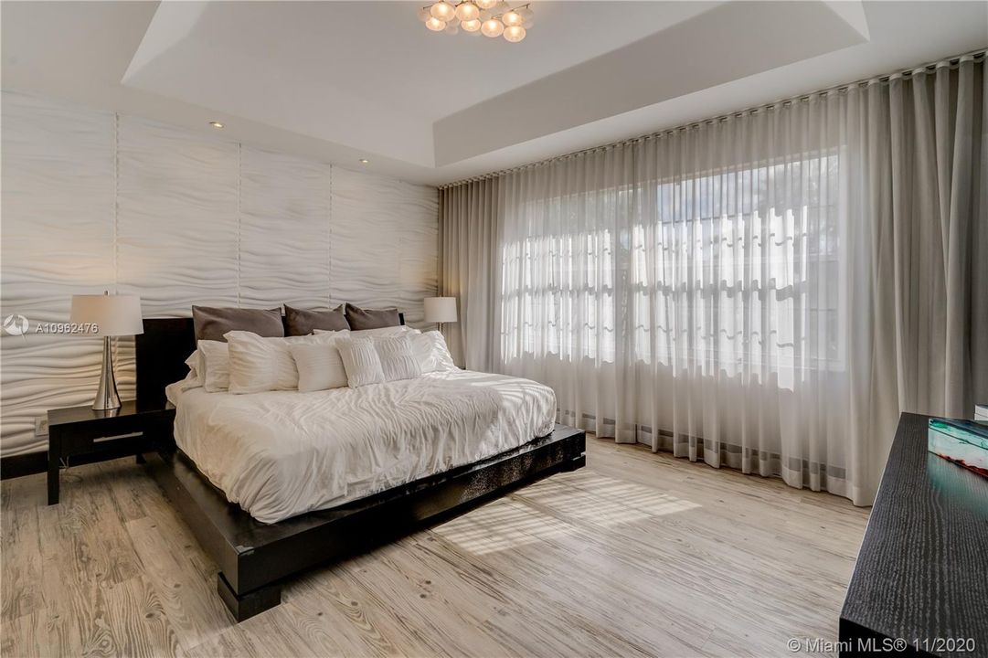 Master bedroom has lots of natural light and gorgeous back wall
