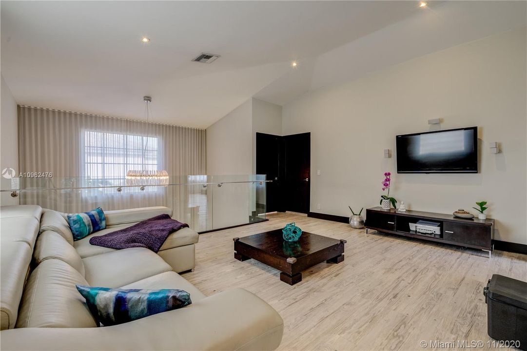 Open loft with lots of natural light surrendered in glass that serves as the ideal home office, guest room, entertainment room and/or home gym. (Sofa is a pull out couch into a full bed)
