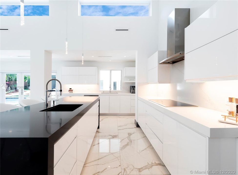White and black quartz counter tops, GE Monogram SS appliances, 48-bottle wine refrigerator.