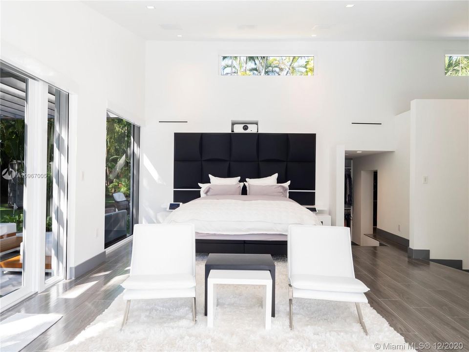 Master bedroom with 94" hidden/drop down motorized screen, projector and Apple TV. Plus an iPad for him and her to control AV.