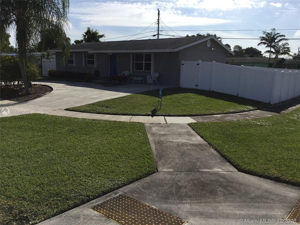 North to South view of large corner lot home & side walks