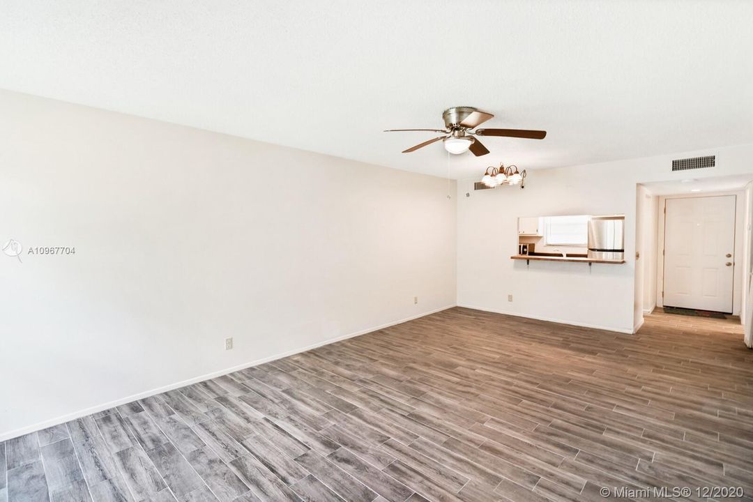 View of main entrance and kitchen from living room