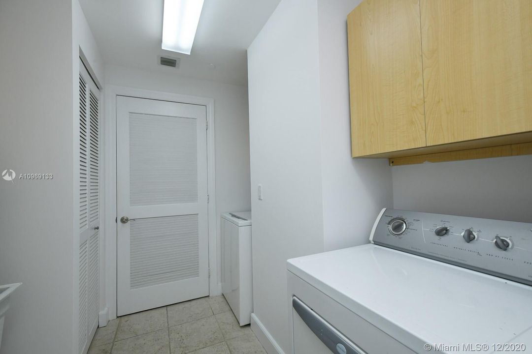 large in unit laundry room with storage & sink