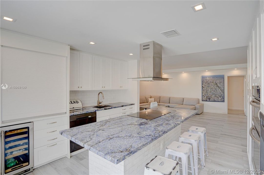 Beverage refrigerator and appliance garage are some of the details this inviting penthouse kitchen features.