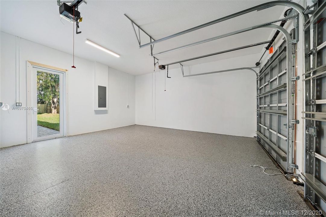 2 Car garage with separate doors, epoxy flooring and access to back yard