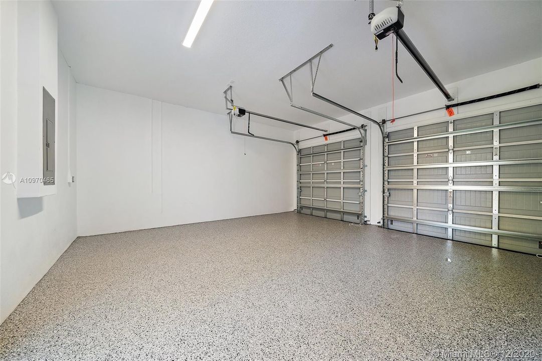 2 car garage with separate doors and epoxy flooring