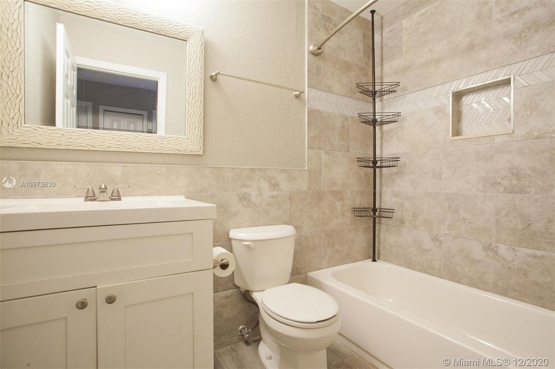 Hallway bathroom with tub