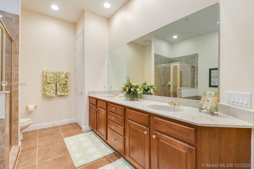 Dual sinks in master bathroom with linen closet