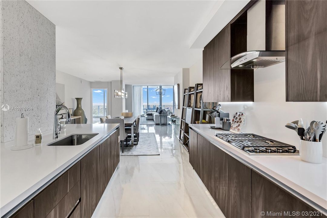 Wolf Gas Cooktop, Quartz Countertops & Italian Cabinetry.