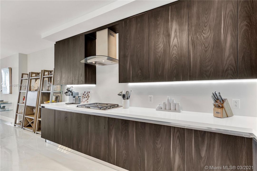 Wolf Gas Cooktop, Quartz Countertops & Italian Cabinetry.