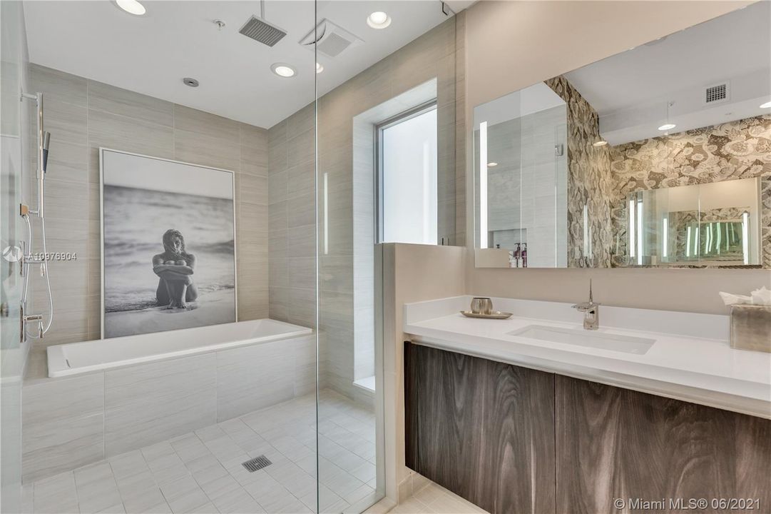 Dual Vanities & Glass Enclosed Shower & Tub.