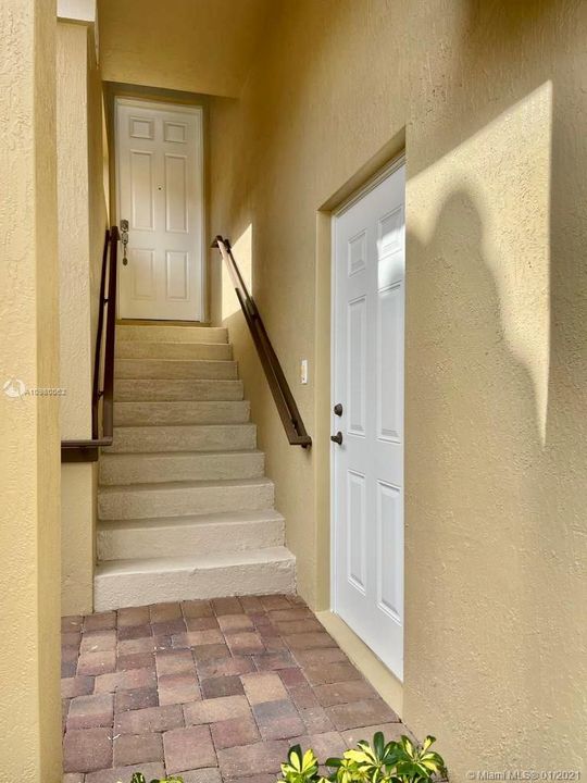 Side door from garage up the stairs to unit front door