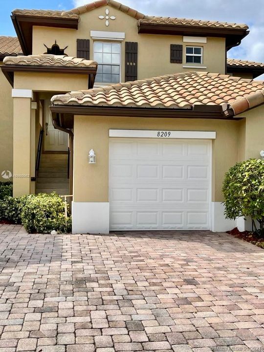 Garage and space for two cars on the driveway.