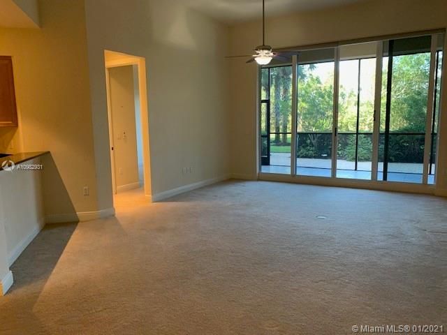 VIEW TO THE LIVING ROOM, PATIO AND ENTRANCE TO THE FIRST BEDROOM