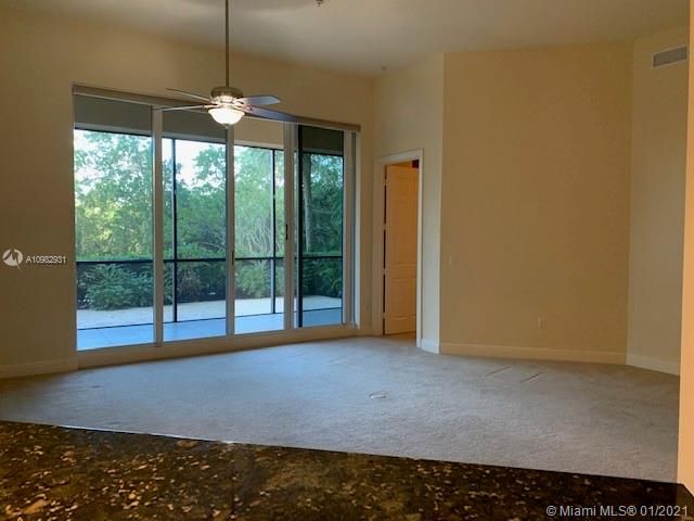 VIEW TO THE LIVING ROOM FROM THE KITCHEN AND ENTRANCE TO THE MASTER ROOM ON THE RIGHT