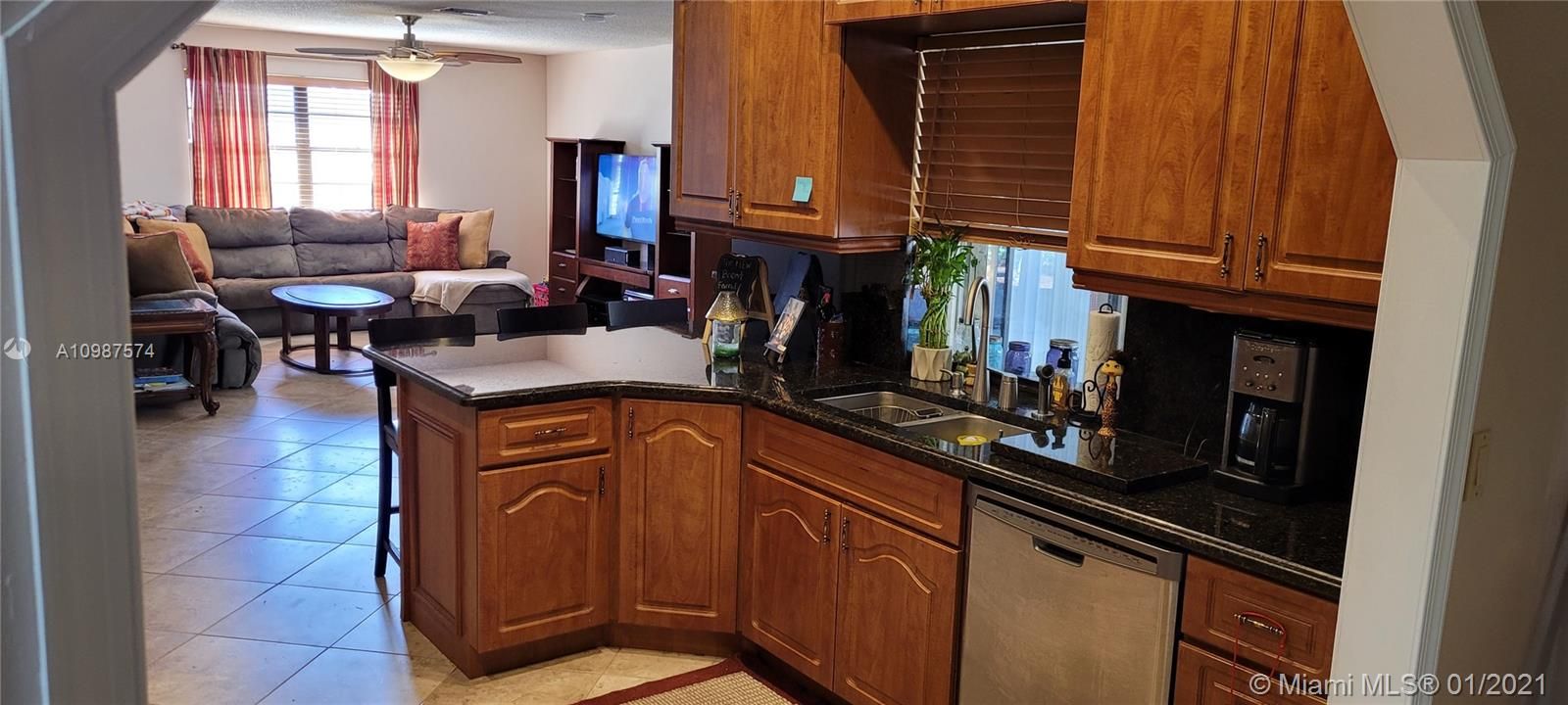 Kitchen with passthrough to screened porch & adjacent to family room