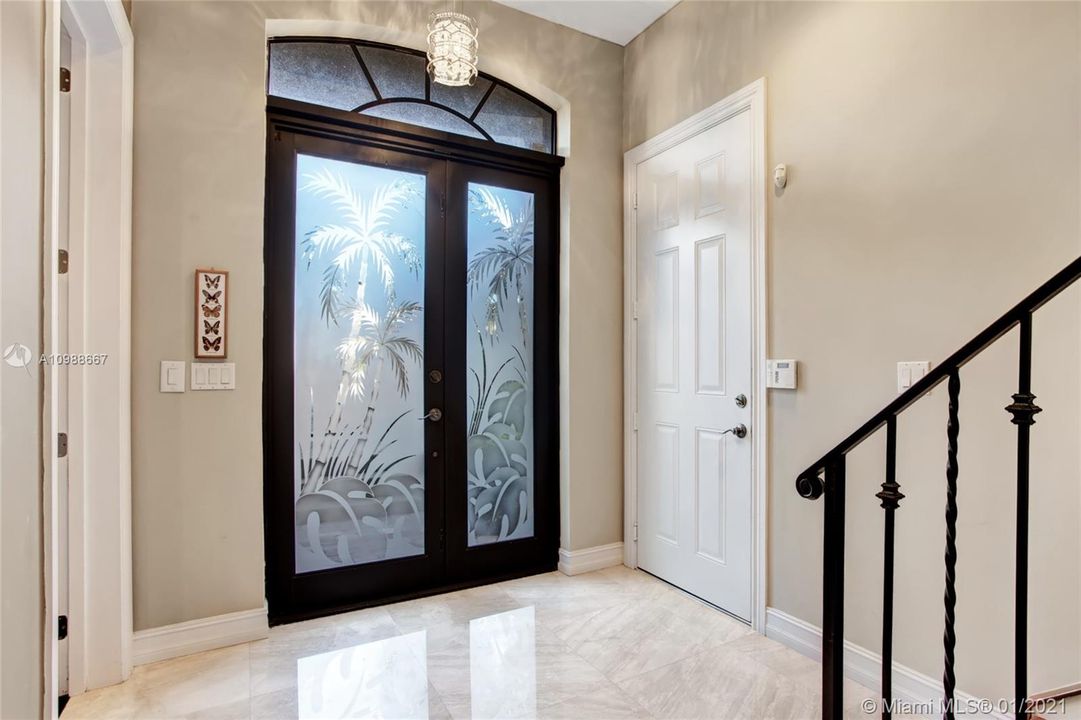 Foyer entry including 3rd bedroom/bathroom, private elevator, garage access and staircase.