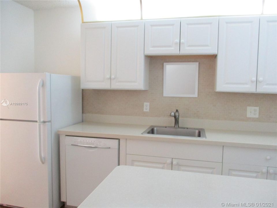 Kitchen white cabinets with tan counter tops