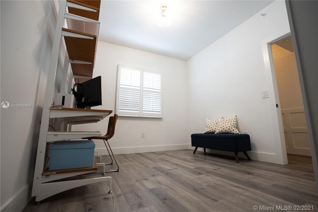 Approximately 11' x 10' 6" Guest room / Den includes modern solid wood doors including trim combined glass doorknobs, Hunter Douglas Plantation Shutters window treatments, 50 years warranty high density 7mm engineered look like wood vinyl flooring throughout and modern baseboards.