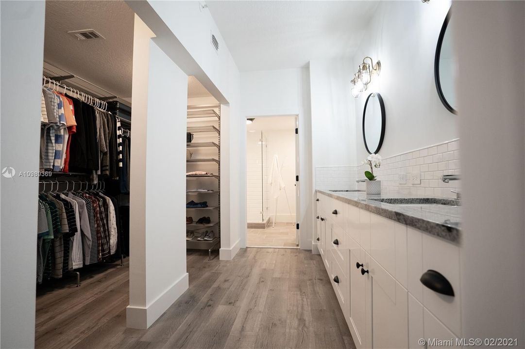 Approximately 19' x 12' Master Bathroom / Walking Closet area that displays Kohler double sinks with Grohe Faucets, Porcelanosa tiles, brand new cabinets, granite countertops, Farmhouse lighting and 50 years warranty high density 7mm engineered look like wood vinyl flooring.