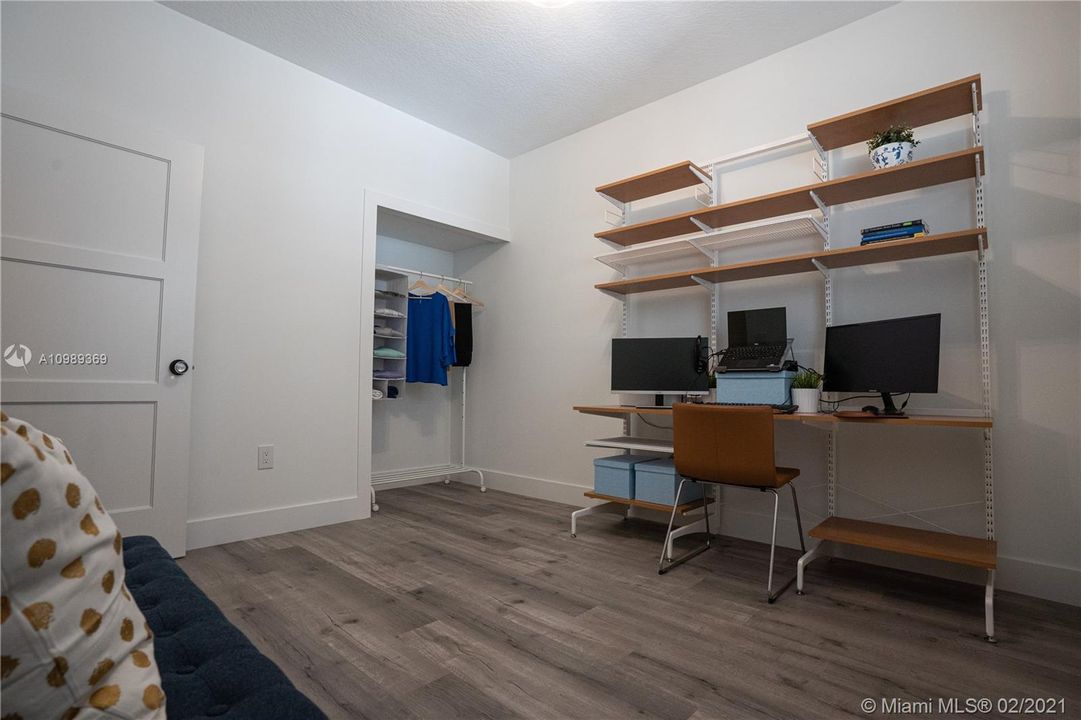 Approximately 11' x 10' 6" Guest room / Den includes modern solid wood doors including trim combined glass doorknobs, Hunter Douglas Plantation Shutters window treatments, 50 years warranty high density 7mm engineered look like wood vinyl flooring throughout and modern baseboards.