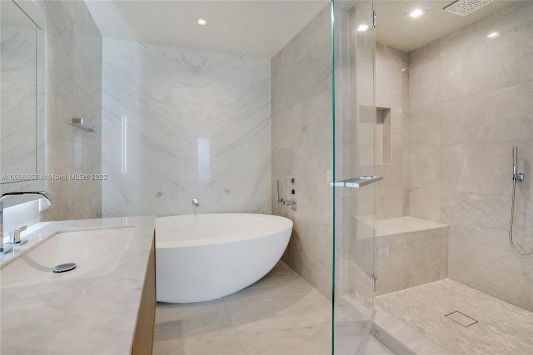 Master bathroom with separated bathtub and shower with glass