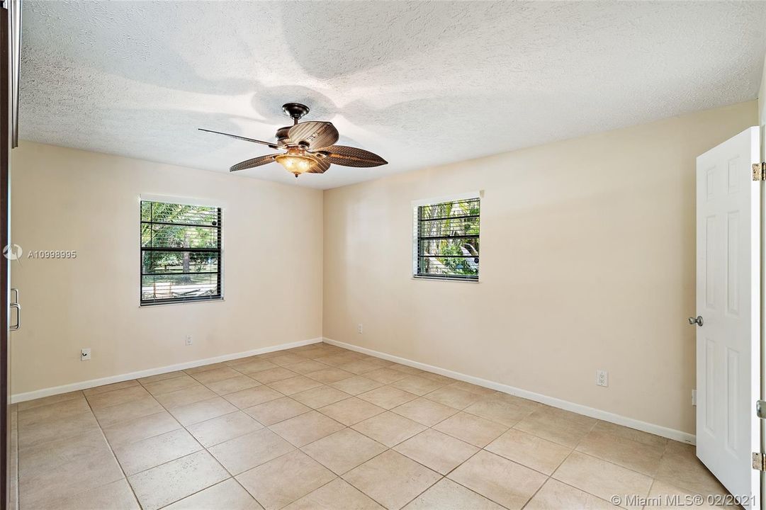 Master bedroom with a storage cabinet and a walk-in closet. Private bathroom.