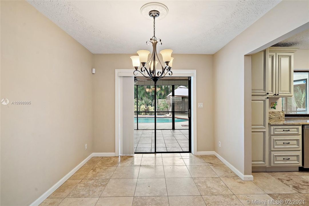 Dining room with slider doors out to screened in lanai.