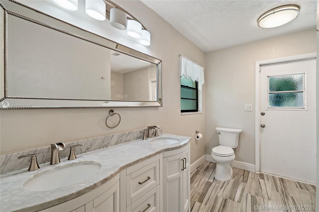 Master bathroom with dual vanities and shower.