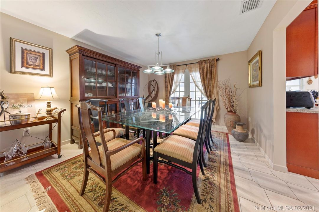 FORMAL DINING ROOM WITH FRENCH DOORS TO THE FLORIDA ROOM