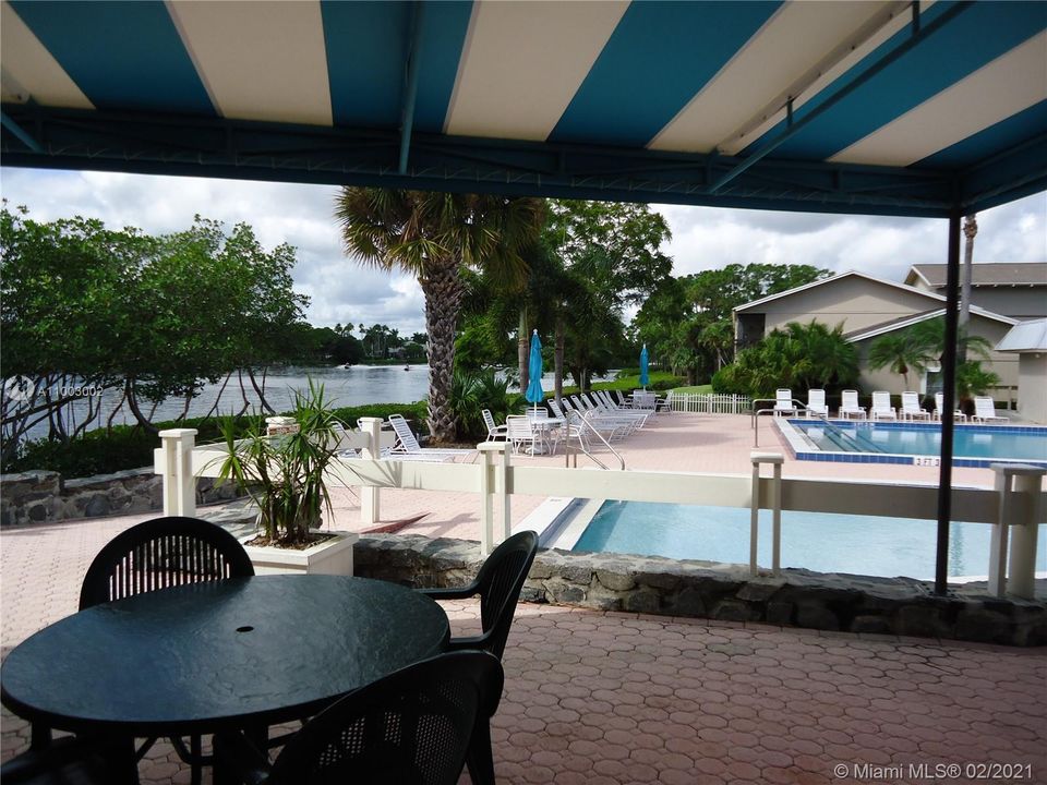 BBQ and dining areas along the pool and river.