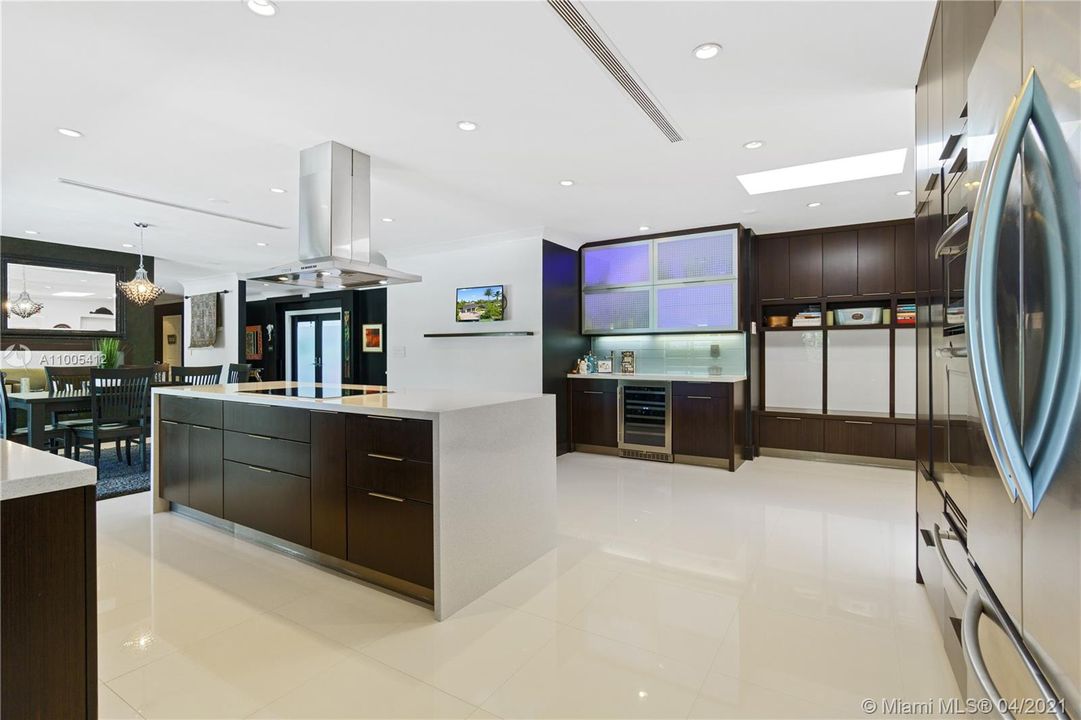 Kitchen/Bar Area with lighted cabinets and wine fridge