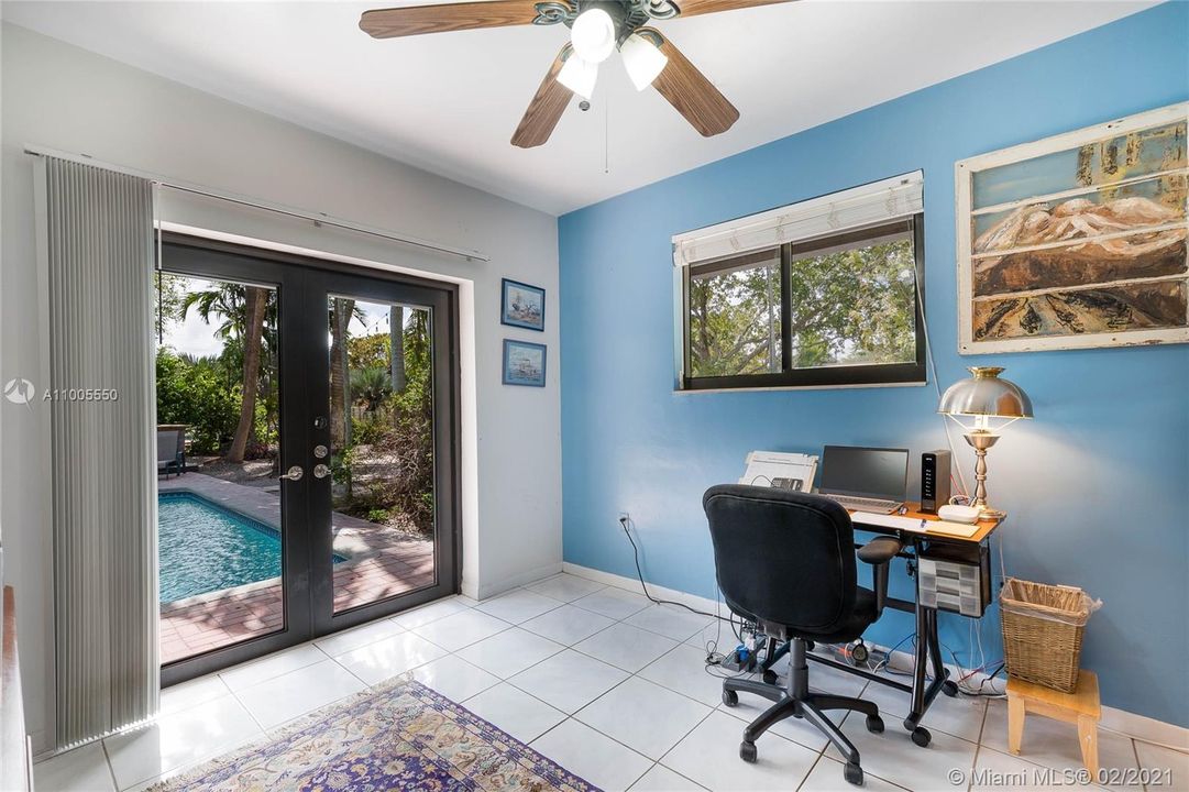 Bedroom with French doors to pool area.