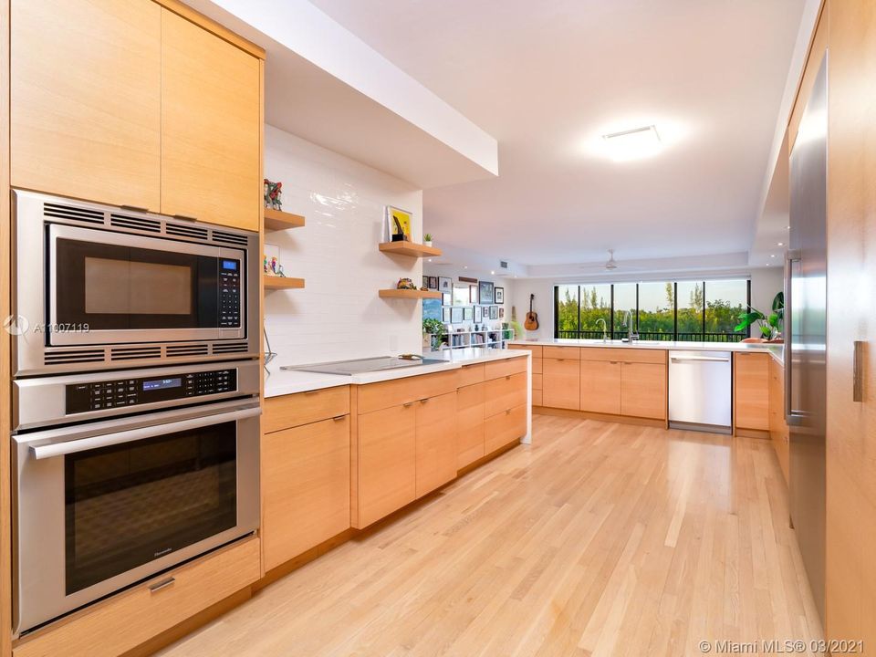 Newly updated open kitchen with custom cabinetry.