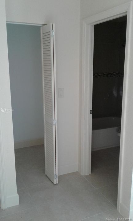 Inside Master bedroom viewing into private bath and walk in closet