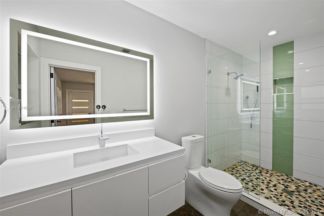 Third guest bathroom in each bedroom. Completely remodeled. This one has a door to the pool area.