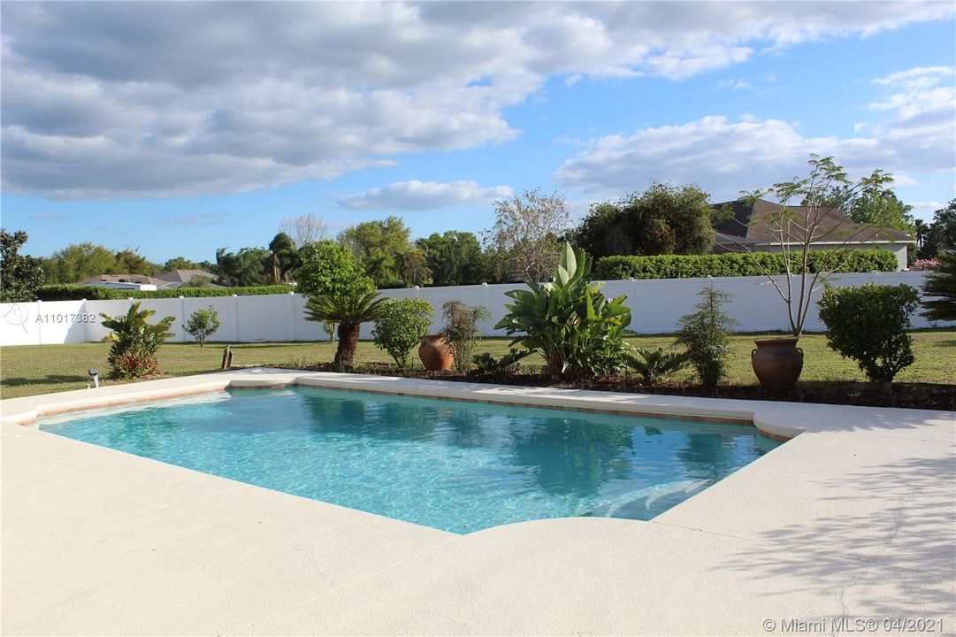 Fully fenced OVERSIZED backyard with a pool.