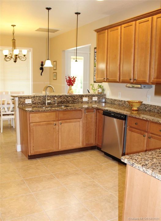 Large Kitchen  opens to a Breakfast area with pool views