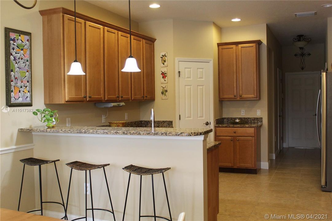 Large Kitchen with a  breakfast bar and a large pantry closet/storage.  Additional large storage closet down the hall.