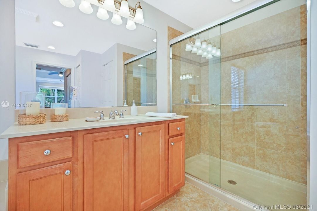 Master Bathroom Second Sink Area with Oversized Shower. Water Closet Separate, Can Be Seen in Mirror Reflection.