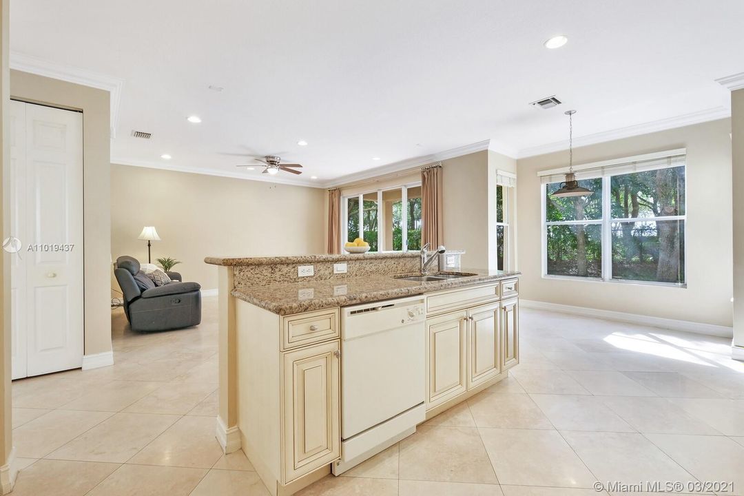 Kitchen Granite Work Space with Bar for Additional Seating Plus Sit-In Dining Area