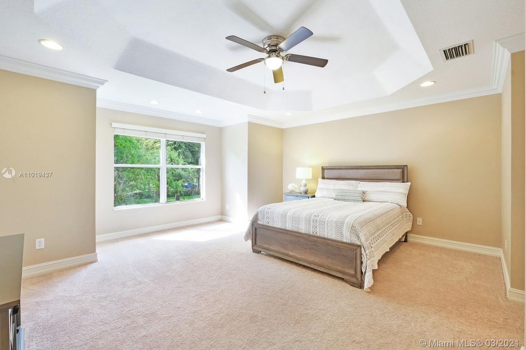 Spacious Master Suite with Tray Ceiling Detail and Extra Room for Window Seating Area