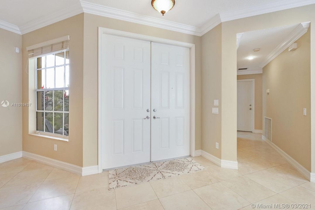 Entry Door with View of Hallway and Dining Room Partial