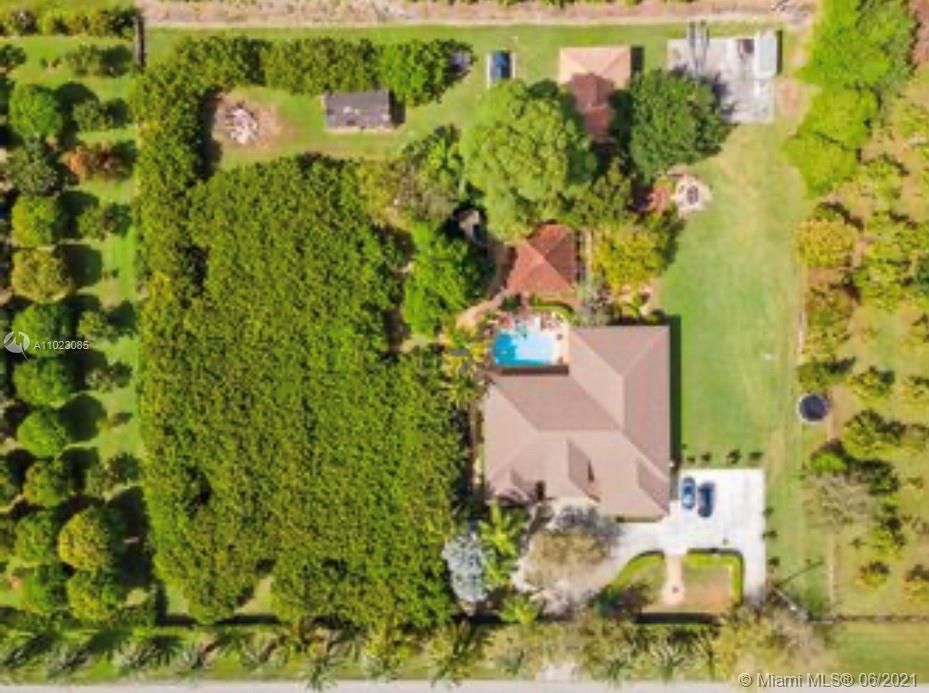 Aerial View of the House, pool, Longan grove, & Detached garage