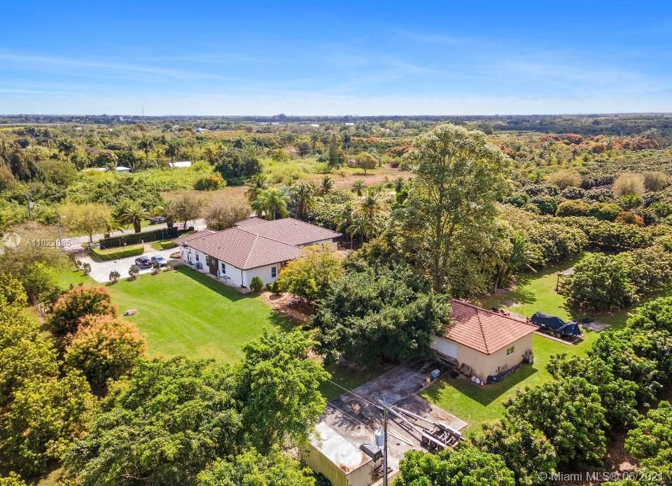 Aerial view of the 2+ Acre property featuring Custom built home, large pool/spa, Party cabana, detached garage, Longan grove w/ assorted fruit trees.