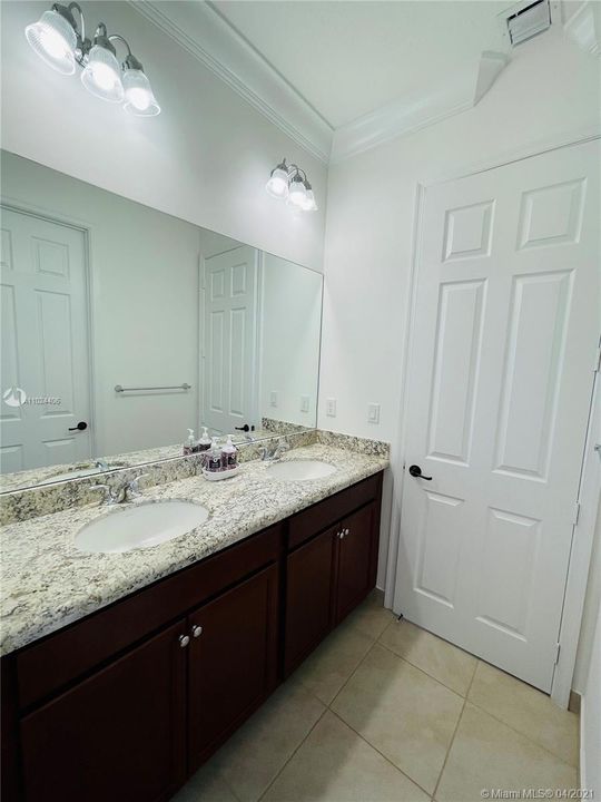 Jack and jill double sink features granite tops.