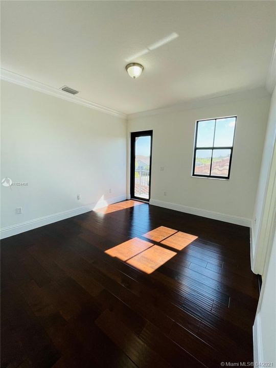 Bedroom with walk-in closet, private balcony, and jack-and-jill shared bathroom.