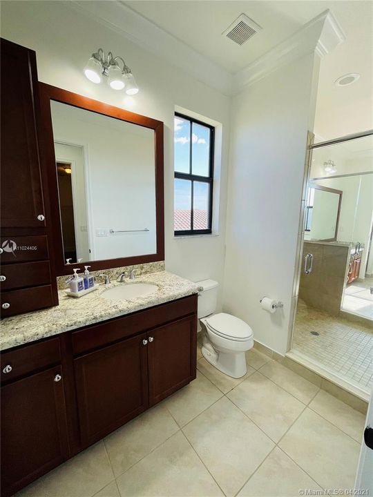 Private entry to master bathroom. The master bathroom has two separate door entries and the bathroom features his and her vanities and toilets.